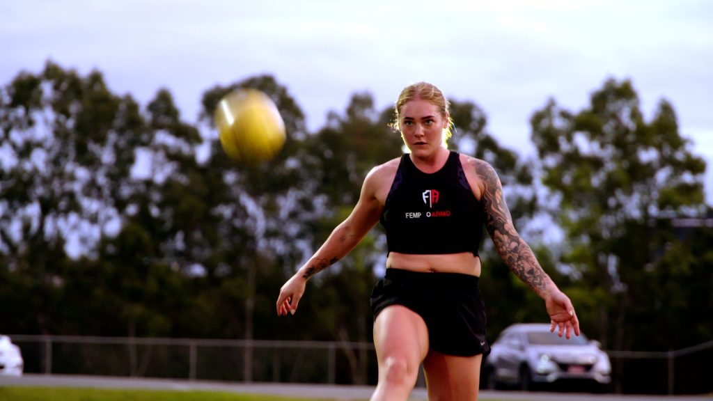 Woman kicking a football