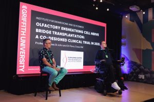 Professor James St John and Perry Cross OAM sitting on stage