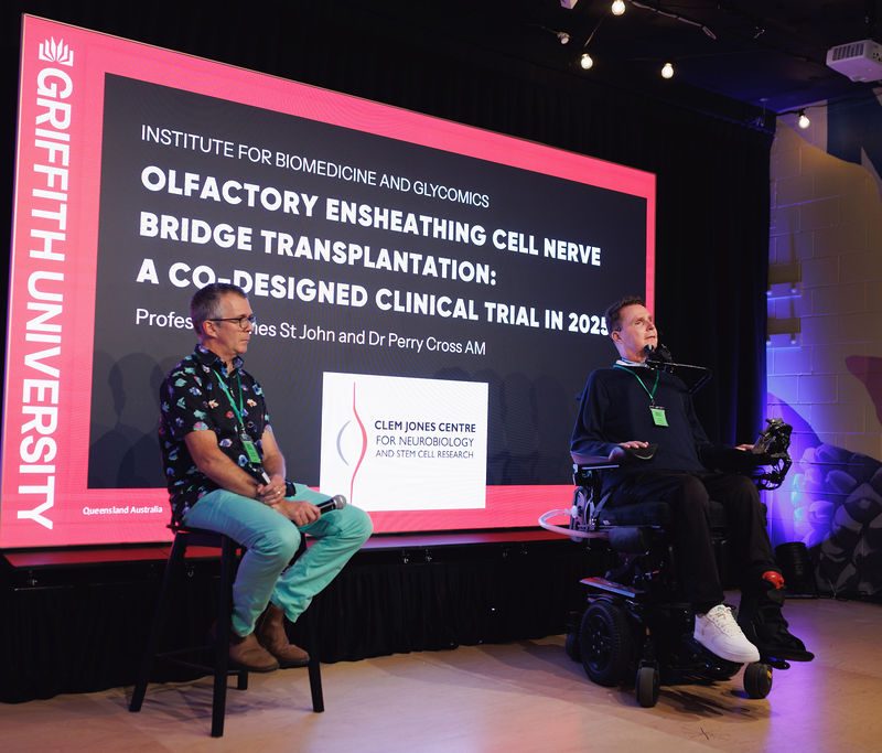 Professor James St John and Perry Cross OAM sitting on stage