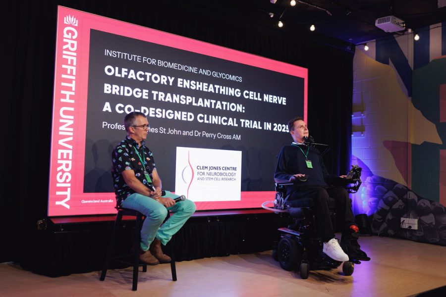 Professor James St John and Perry Cross OAM sitting on stage