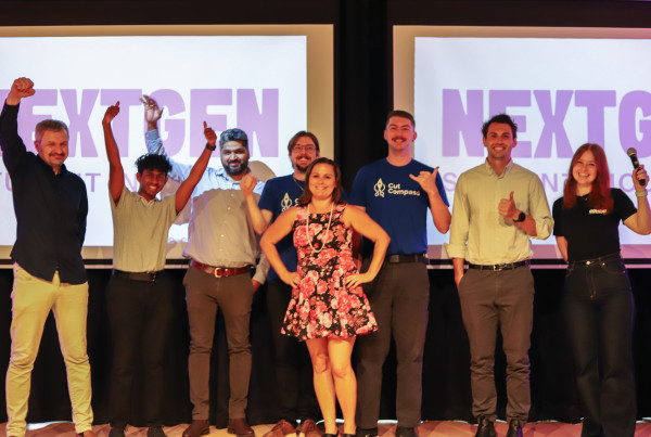 All seven student and researcher-led startup teams gather on stage for a group photo at the end of the 2025 NextGen Pre-Accelerator Demo Night.