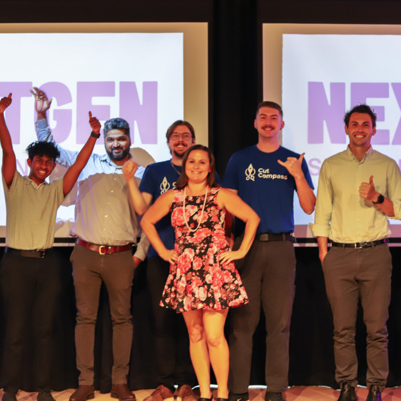 All seven student and researcher-led startup teams gather on stage for a group photo at the end of the 2025 NextGen Pre-Accelerator Demo Night.