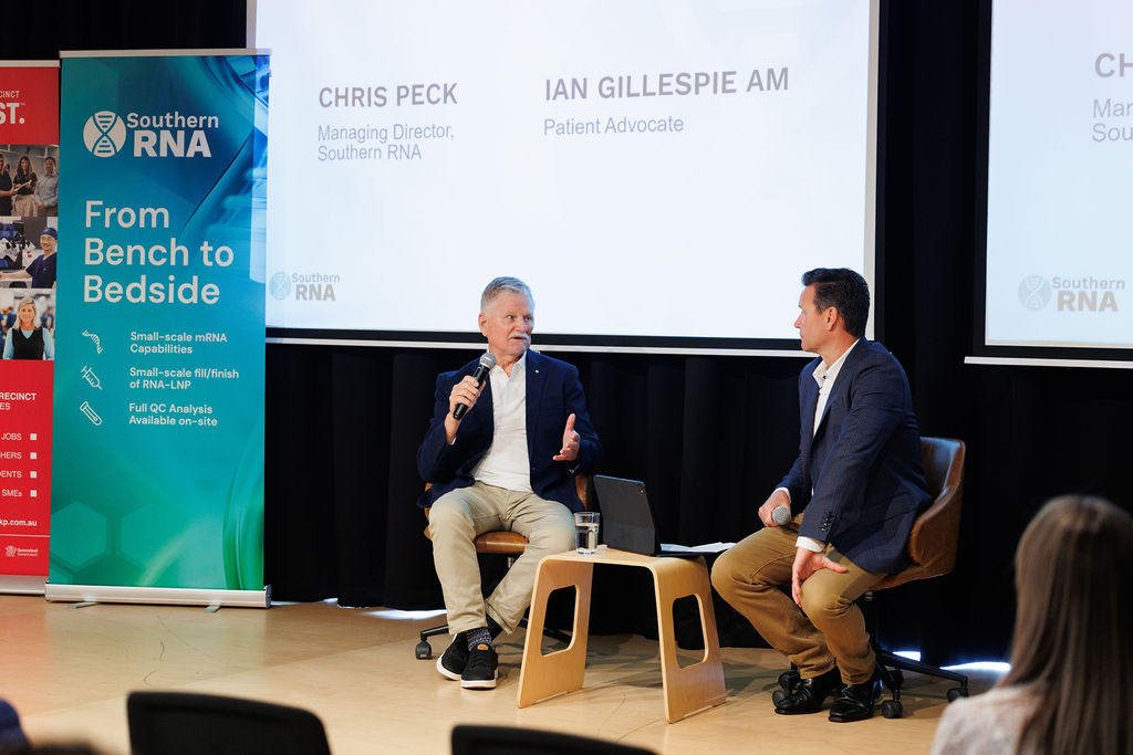 Chris Peck and patient advocate Ian Gillespie AM share a conversation on stage about Ian’s experience receiving a personalised cancer vaccine developed through Southern RNA’s collaboration with Providence Therapeutics.