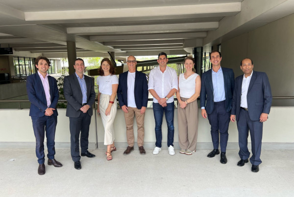 Group of Flo Axiom team members and partners standing together at Griffith University following spinout and investment announcement