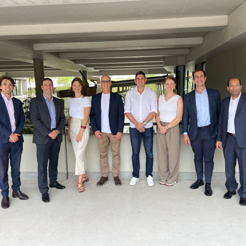Group of Flo Axiom team members and partners standing together at Griffith University following spinout and investment announcement