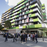 Delegates walking through the Gold Coast Health and Knowledge Precinct during a site tour, passing the Smith Collective residential buildings.