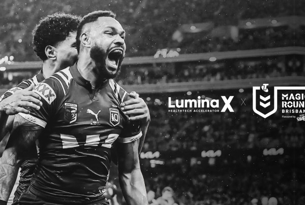 NRL player celebrating during a match with LuminaX HealthTech Accelerator and Magic Round Brisbane logos overlaid
