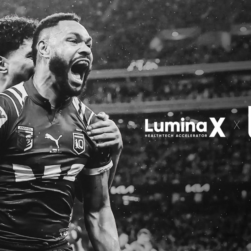 NRL player celebrating during a match with LuminaX HealthTech Accelerator and Magic Round Brisbane logos overlaid
