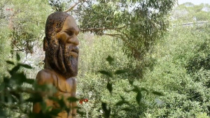 Statue of Jabreen, a Dreaming spirit, positioned within native bushland reflecting connection to Country and landscape.