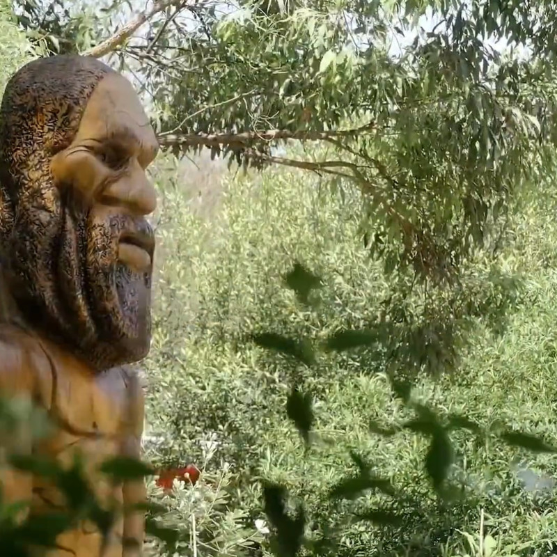 Statue of Jabreen, a Dreaming spirit, positioned within native bushland reflecting connection to Country and landscape.
