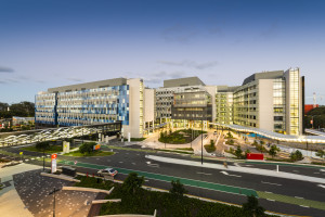Exterior view of Gold Coast University Hospital following its opening in 2013, showing the modern multi-building hospital facility and landscaped entrance at dusk.