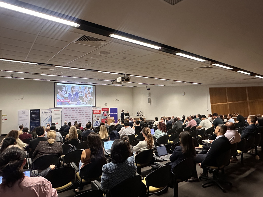 AusBiotech 2026 delegates attending a research presentation at Griffith University's Institute for Biomedicine and Glycomics during a tour of the Gold Coast Health and Knowledge Precinct.
